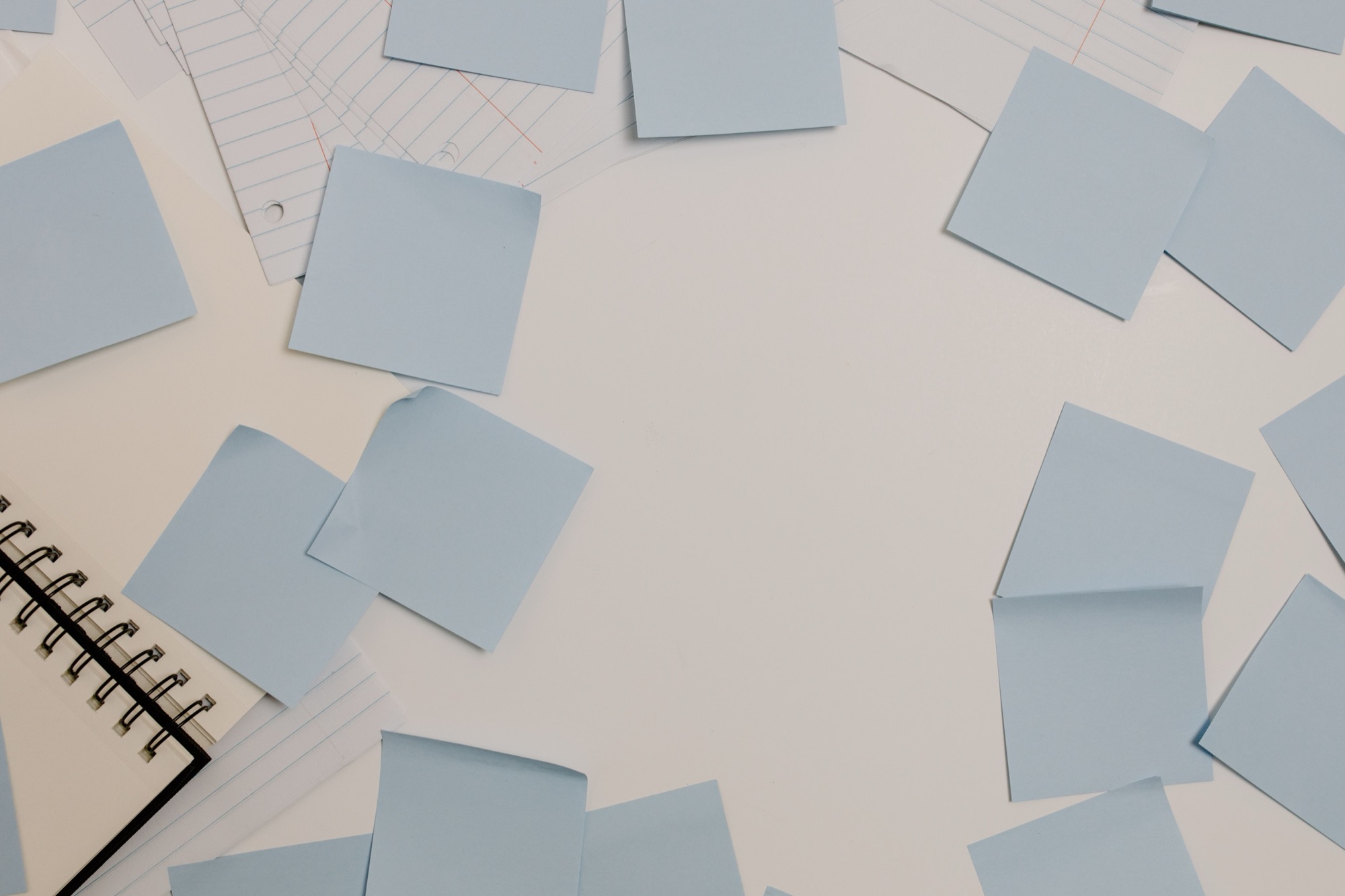 Loose sticky notes and papers spread across a desk