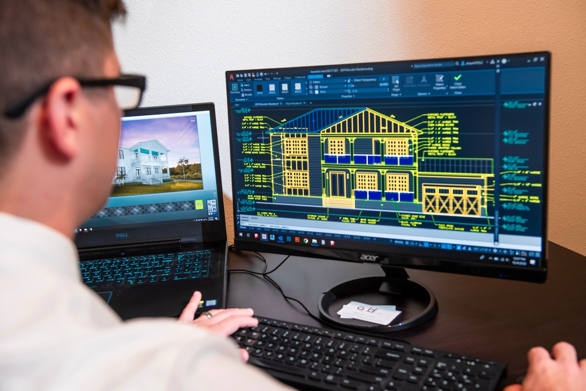 A systems drawing on a desktop beside a laptop